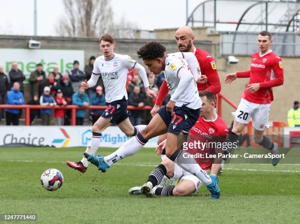 Bolton Wanderers' Shola Shoretire shoots at goal despite the attentions of Morecambe's Donald Love but it was saved during the Sky Bet League One...