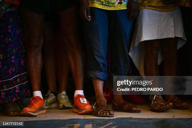Athletes and long-distance runners of the Raramuri community wait for the start of the ultramarathon "Caballo Blanco" in Urique, Chihuahua State,...