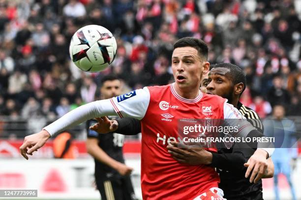 Reims' French forward Alexis Flips and Ajaccio's Comorian defender Mohamed Youssouf go for a header during the French L1 football match between Stade...