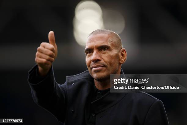 Stan Collymore gestures to Nottingham Forest fans as he walks around the pitch at half time during the Premier League match between Nottingham Forest...