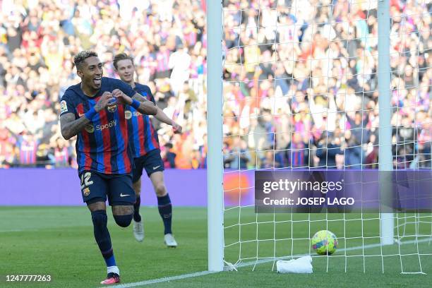 Barcelona's Brazilian forward Raphinha celebrates scoring his team's first goal during the Spanish League football match between FC Barcelona and...