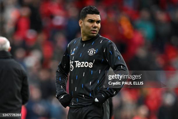 Manchester United's Brazilian midfielder Casemiro warms up ahead of the English Premier League football match between Liverpool and Manchester United...