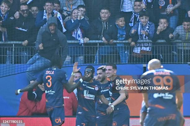 Montpellier's French midfielder Teji Savanier celebrates with teammates after scoring the fourth goal for his team during the French L1 football...