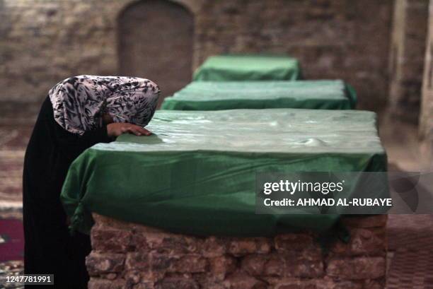 Muslim woman kisses one of the tombs belonging to the four companions of the Jewish prophet Ezekiel at his tomb, today a mosque, in the little town...