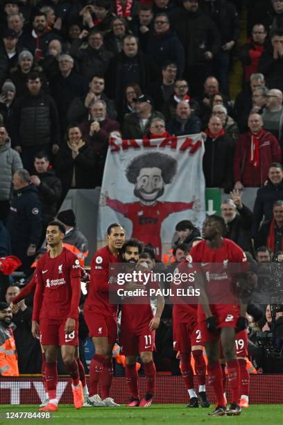 Liverpool's Egyptian striker Mohamed Salah celebrates with teammates after scoring their fourth goal during the English Premier League football match...