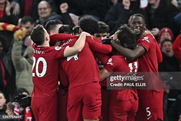 Liverpool's Brazilian striker Roberto Firmino celebrates with teammates after scoring their seventh goal during the English Premier League football...