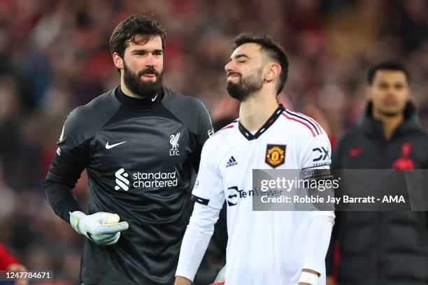 Dejected Bruno Fernandes of Manchester United with Alisson Becker of Liverpool after losing 7-0 during the Premier League match between Liverpool FC...