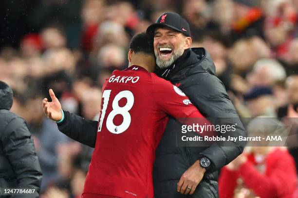 Cody Gakpo hugs Jurgen Klopp the head coach / manager of Liverpool after he is substituted during the Premier League match between Liverpool FC and...