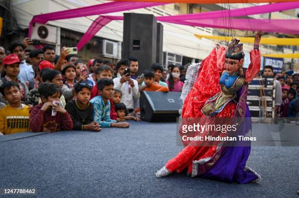 Puppeteer shows the puppet dance to children during Raahgiri Day at Kamla Nagar , on March 5, 2023 in New Delhi, India. Raahgiri Day is a street...