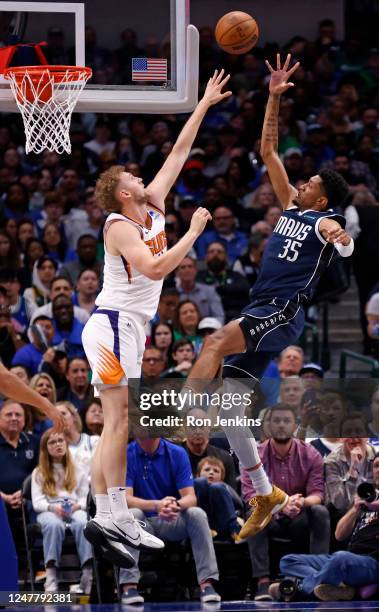 Christian Wood of the Dallas Mavericks shoots the ball as Jock Landale of the Phoenix Suns defends the basket in the second half of the game at...