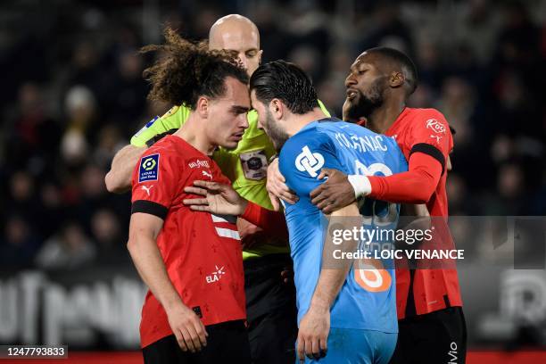 Rennes' Belgian defender Arthur Theate argues with Marseille's Bosnian defender Sead Kolasinac during the French L1 football match between Stade...