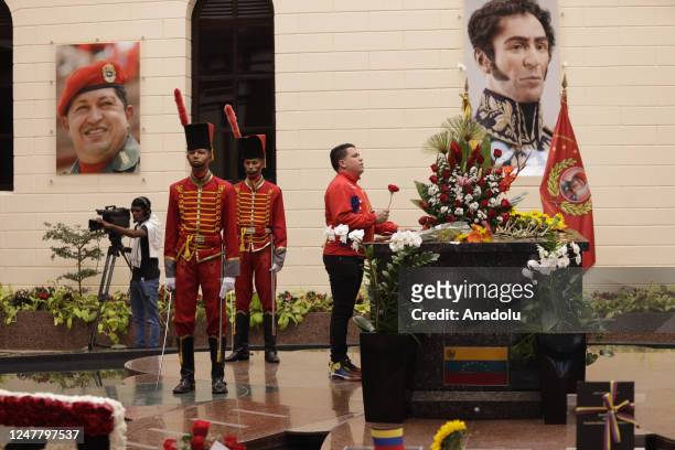 Visitors pay their respects at the tomb of the late Venezuelan President Hugo Chavez during commemorations of the 10th anniversary of his death,...