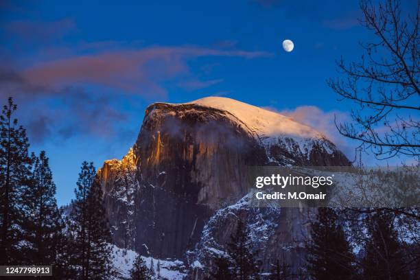 half dome with the moon at yosemite national park just after sunset. - half dome stock pictures, royalty-free photos & images