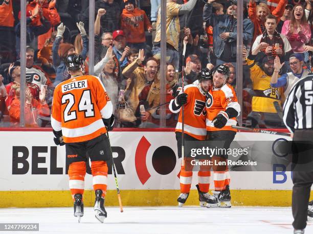 Noah Cates of the Philadelphia Flyers celebrates his second period goal against the Detroit Red Wings with Nick Seeler and Brendan Lemieux at the...