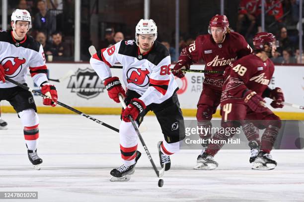 Kevin Bahl of the New Jersey Devils skates with the puck during the first period against the Arizona Coyotes at Mullett Arena on March 05, 2023 in...