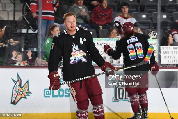 Lawson Crouse of the Arizona Coyotes skates during warmups wearing a special Pride Night jersey prior to a game against the New Jersey Devils at...