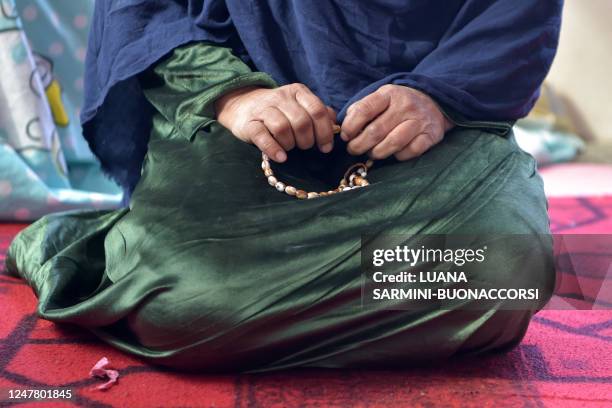 In this photo taken on February 1 Marwa, a divorced woman whose name has been changed for her protection, holds prayer beads as she speaks during an...