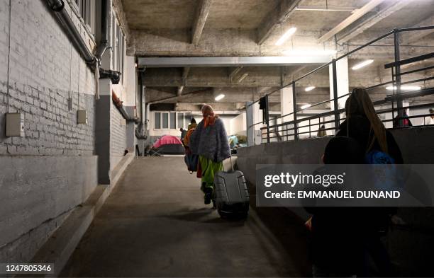 People in administrative difficulties, including undocumented and migrants and asylum seekers, arrive at a parking lot transformed into a temporary...