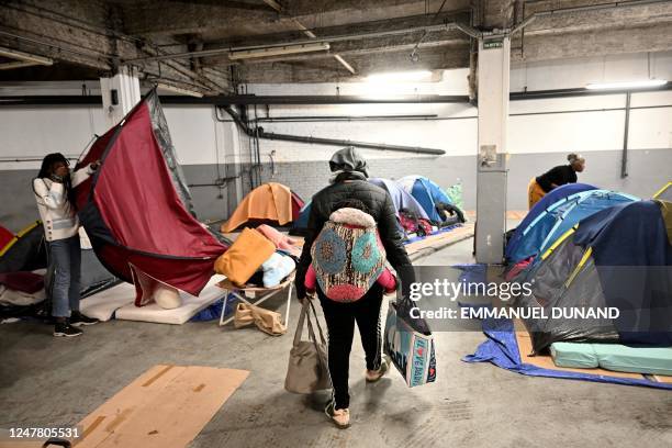 People in administrative difficulties, including undocumented and migrants and asylum seekers, settle in a parking lot transformed by the...