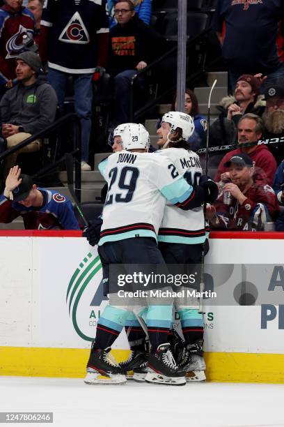 Yanni Gourde, Vince Dunn and Jared McCann of the Seattle Kraken celebrate the game-winning goal against the Colorado Avalanche at Ball Arena on March...