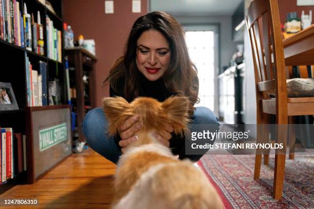 Khatereh Borhani, who goes by KB, pets her dog Lexi at her home in Baltimore, Maryland, on February 28, 2023. - Borhani was born in Iran and fled to...