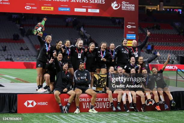 Players of New Zealand pose with the trophy after the final game of the World Rugby Seven Series 2023 BC Place Stadium in Vancouver, British...