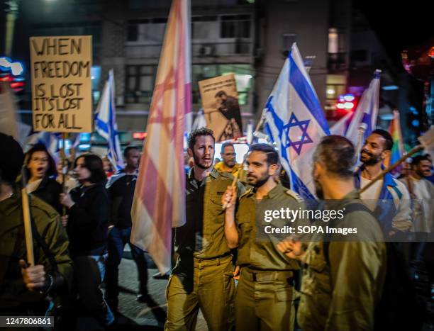 Israeli reserve soldiers march during a demonstration. Over 400,000 people protested all over Israel for the ninth consecutive week against a...