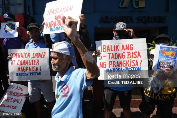 Jeepeney driver raises a clinched fist during a rally to coincide with their transport strike in Caloocan City, suburban Manila on March 6, 2023. -...