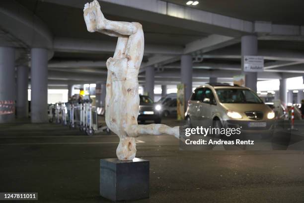 Visitors, sitting in their cars, past drive a sculpture by artist Hubert Mussner at the "Nachtbroetchen 2.0" drive-in Pop-up-Exhibition during the...