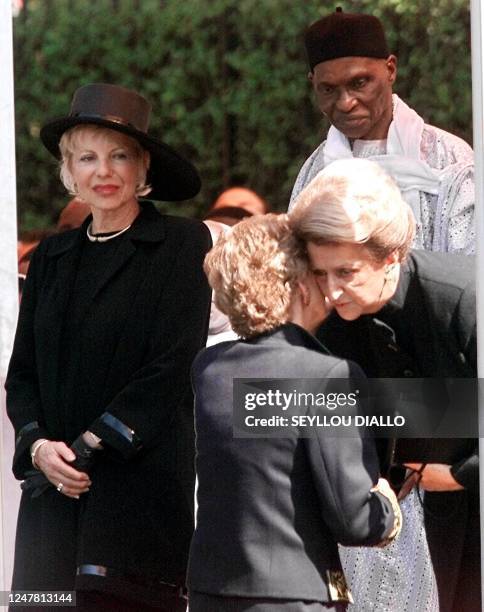 Colette Senghor , the widow of former Senegalese president Leopold Sedar Senghor, kisses Secretary General of the Academie Francaise Helene Carrere...