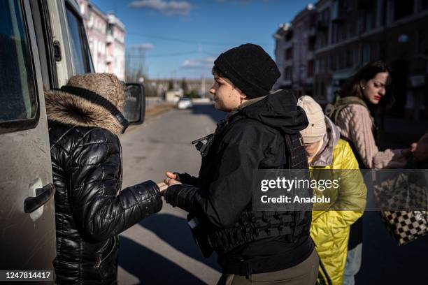 Volunteer of the NGO Road to Relief helps descend an elderly woman from the van in Kramatorsk, Ukraine amid Russia-Ukraine war on March 5 2023. North...