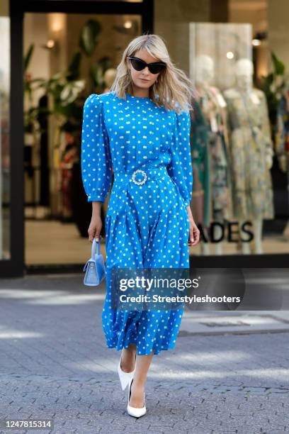 Gitta Banko, wearing a midi length blue dress with white polka dots by Alessandra Rich, a mini light blue croco embossed leather bag by Far, white...