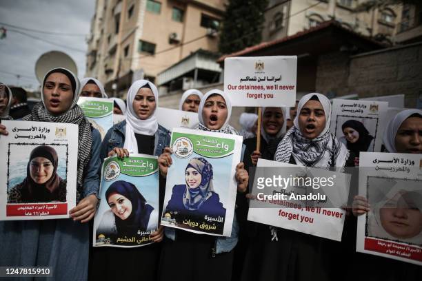 People, holding banners and the photos of Palestinian female prisoners in Israeli jails, hold a protest in support of them in front of the...