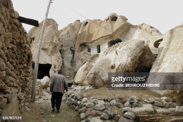 An Iranian Azeri walk towards his cave dwelling house in the Iranian troglodyte village of Kandovan, about 60 kms south of Tabriz, the capital of...