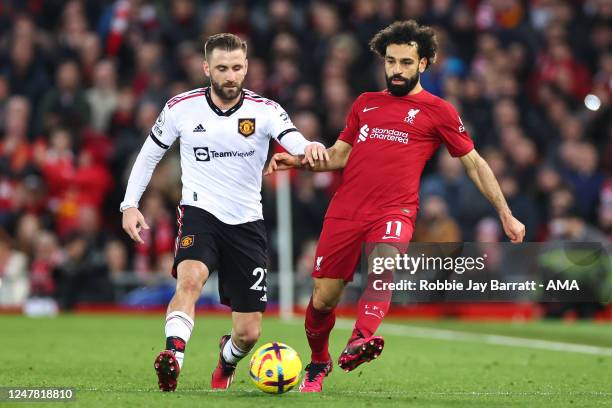 Luke Shaw of Manchester United and Mohamed Salah of Liverpool during the Premier League match between Liverpool FC and Manchester United at Anfield...