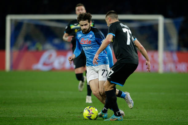 Napolis forward Khvicha Kvaratskhelia challenges for the ball with Lazios Serbian defender Adam Marusic during the Serie A football match between SSC...