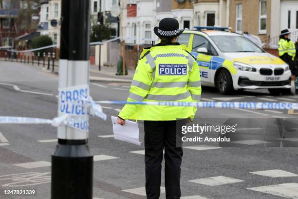 Police officers guard a cordon on Arnold Road in Tottenham, north London, Britain, on March 06 following a fatal stabbing of a man in his 20s. Police...