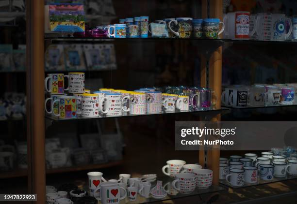 The sun illuminates mugs on display in a gift shop in the historic city of the Mediterranean port of Limassol. Cyprus, Monday, March 6, 2023.