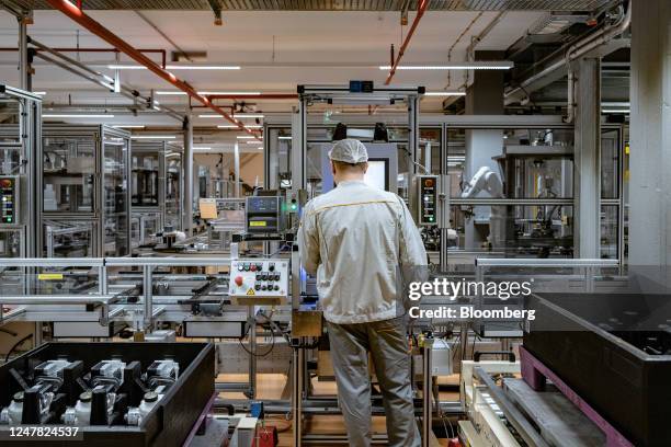 An employee operates a machine on the production line of the MK C2 brake system module at the Continental AG manufacturing plant in Frankfurt,...