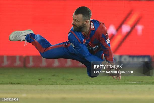 Karachi Kings' Matthew Wade attempts for a catch of Quetta Gladiators' Martin Guptill during the Pakistan Super League T20 cricket match between...