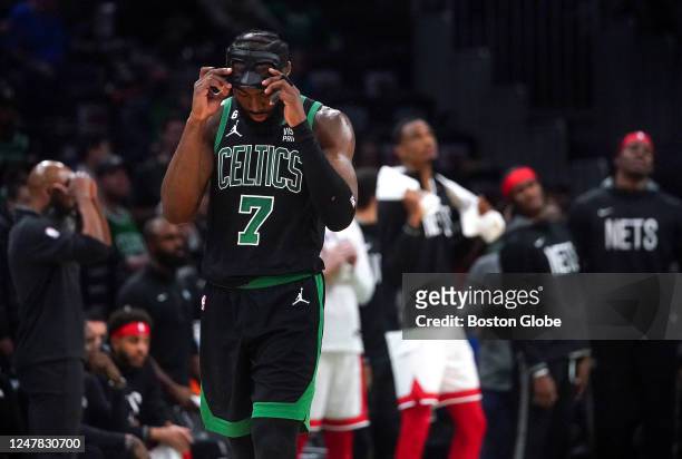 Boston Celtics SG Jaylen Brown takes off his mask following a 115-105 loss to the Brooklyn Nets.