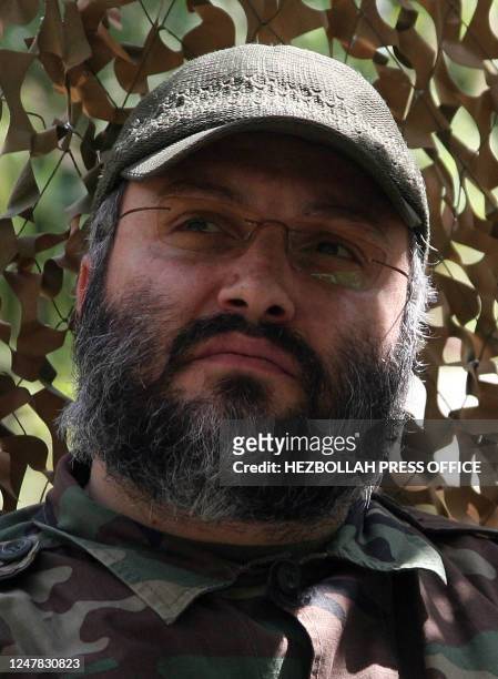 In this undated handout made available by the Hezbollah press office on February 13 top Hezbollah commander Imad Mughnieh is seen sitting in front of...