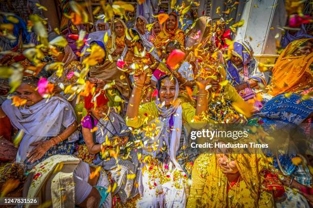 Widows throw petals and Flowers while participating in the Holi festival at Gopinath Temple on March 6, 2023 in Vrindavan, India.