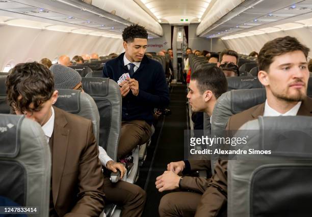 Jude Bellingham of Borussia Dortmund playing cards in the airplane ahead of their UEFA Champions League round of 16 match against Chelsea FC at...