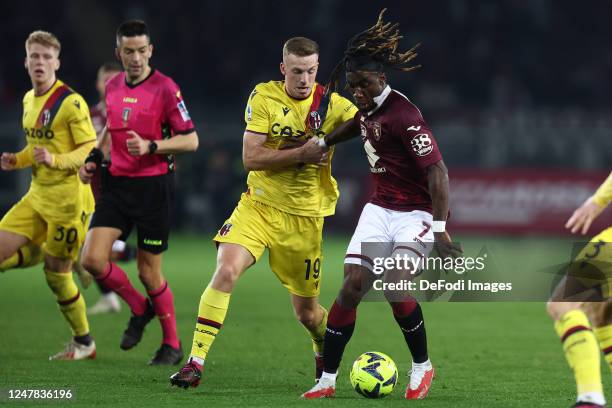 Lewis Ferguson of Bologna Fc and Yann Karamoh of Torino Fc battle for the ball during the Serie A match between Torino FC and Bologna FC at Stadio...