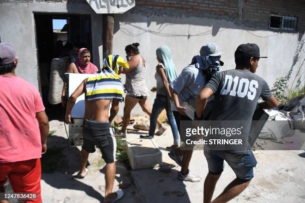 People loot and destroy the house of an alleged drug trafficker in Rosario, Santa Fe province, Argentina, on March 6 in protests over the killing of...