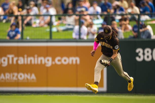 Fernando Tatis Jr. #23 of the San Diego Padres fields a ball hit to right field during a Spring Training game against the Los Angeles Dodgers on...