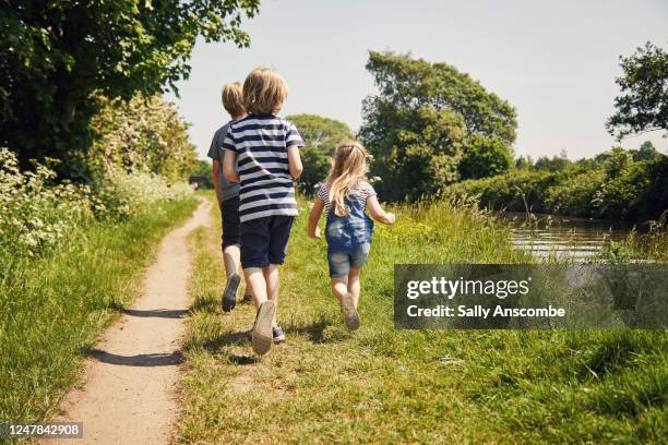 children going for a walk along the canal - lane sisters ストックフォトと画像