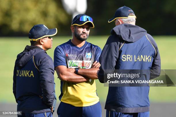 Sri Lanka's Dimuth Karunaratne talks with the team coach Chris Silverwood and the selector on tour Romesh Kaluwitharana during a practice session...