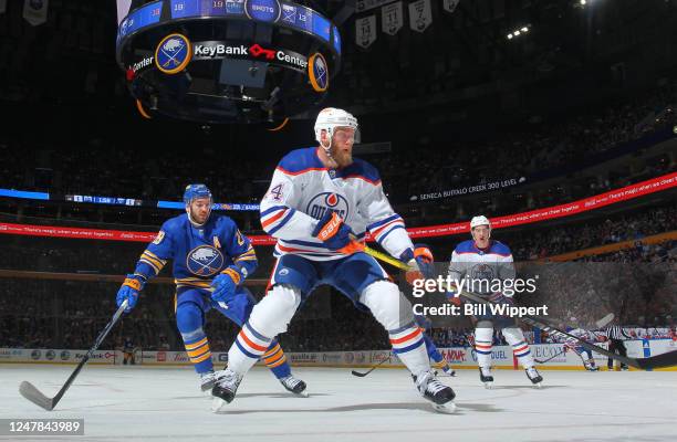 Mattias Ekholm of the Edmonton Oilers follows play ahead of Zemgus Girgensons of the Buffalo Sabres during an NHL game on March 6, 2023 at KeyBank...